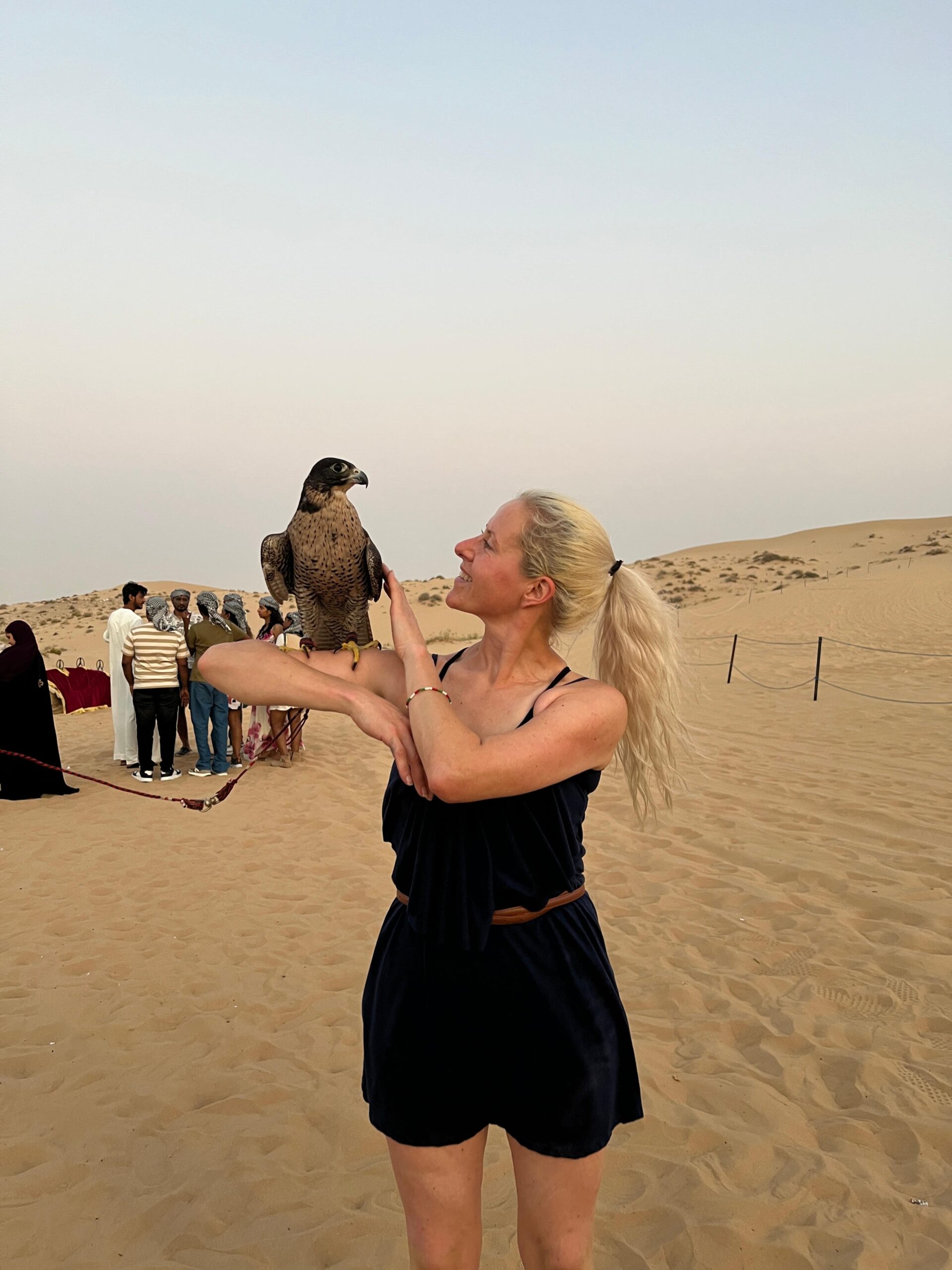 A couple wearing matching traditional Arabic costumes for a romantic photoshoot in Abu Dhabi desert