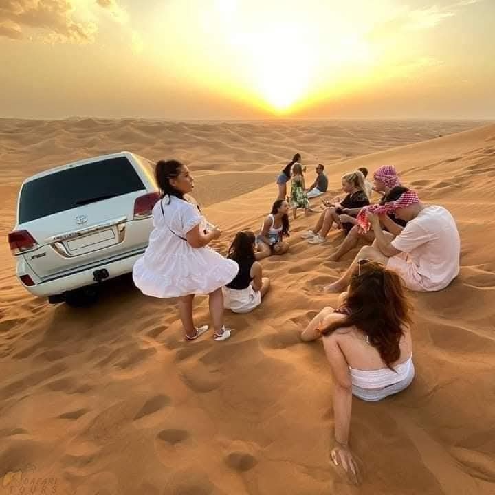 family enjoying evening desert safari in abu dhabi desert safari
