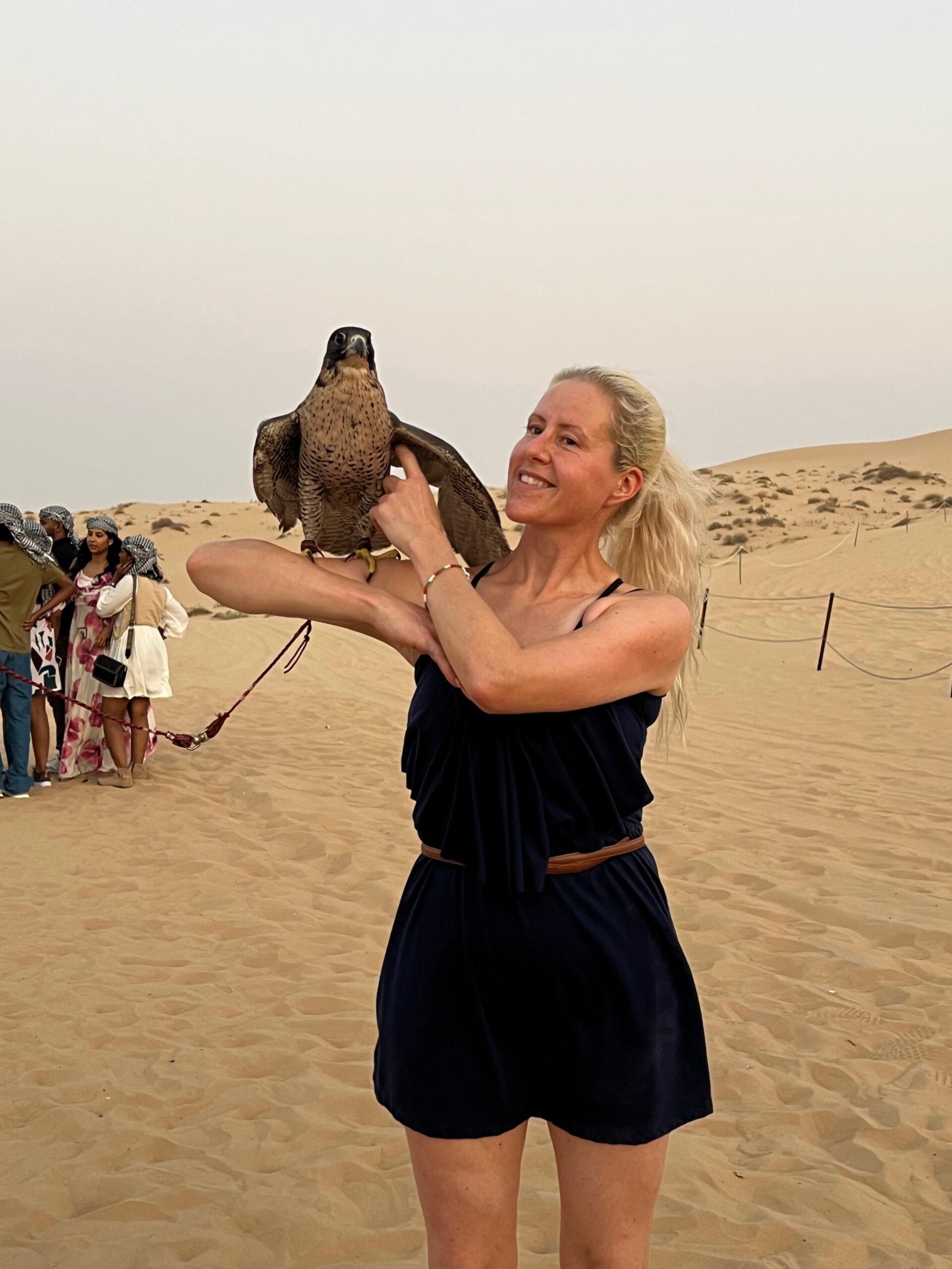 A traditional Tanoura dance performer spinning in colorful skirts at an Abu Dhabi desert camp